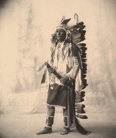 Dressed in black and white clothing stood a man
